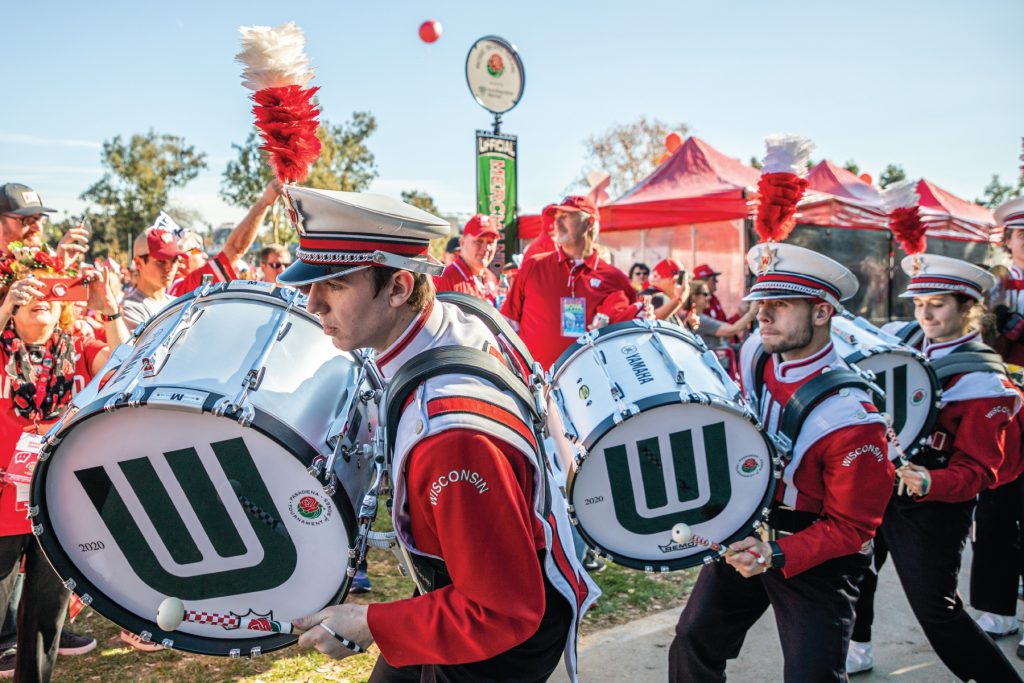 Photo of UW Marching band bass line members playing their drums during a 2020 Rose Bowl pep rally.