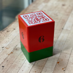 red and green block with barcode stamped on top